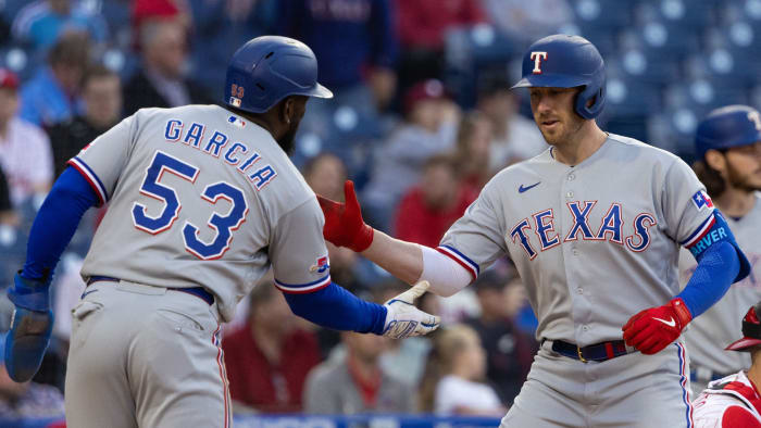 May 3, 2022; Philadelphia, Pennsylvania, USA; Texas Rangers catcher Mitch Garver (18) celebrates with right fielder Adolis Garcia (53) after hitting a two RBI home run during the first inning against the Philadelphia Phillies at Citizens Bank Park.